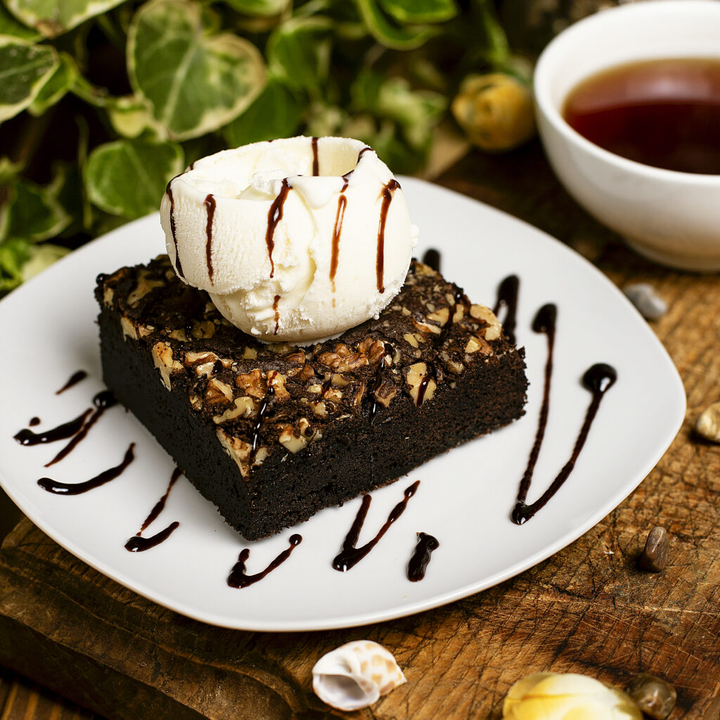 Banana brownies served with a scoop of vanilla ice cream.