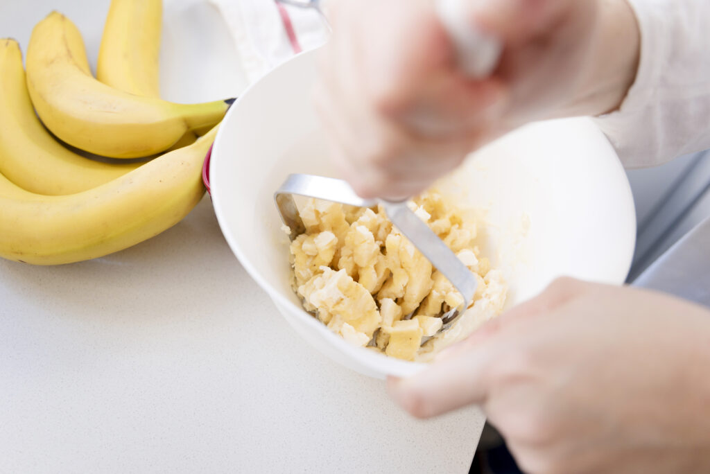 Mashing ripe bananas for the banana brownie recipe.